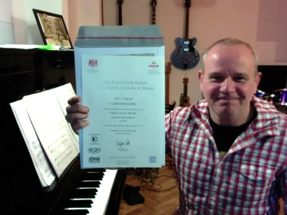 Piano student showing a certificate from their assessment