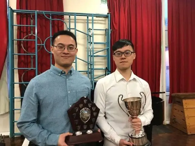 Piano students holding trophies from festivals